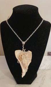 Heart shell necklace on black jewelry stand