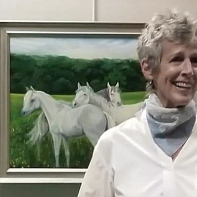 Leslie Anthony in front of her paintings