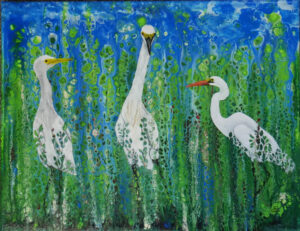 3 tall white birds in marsh plants
