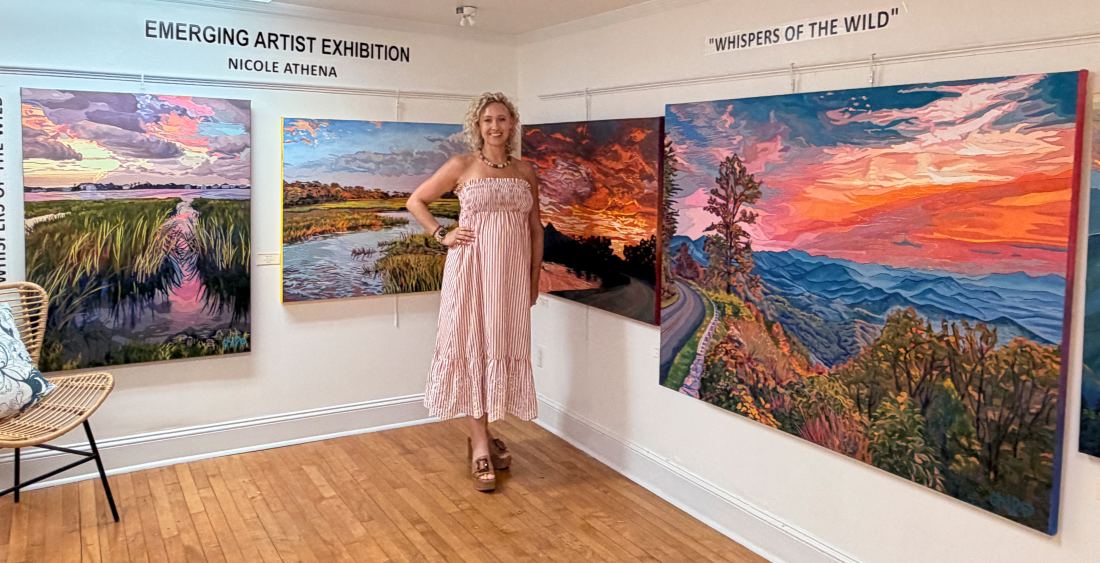 Smiling woman in summer sleeveless dress in front of artwork